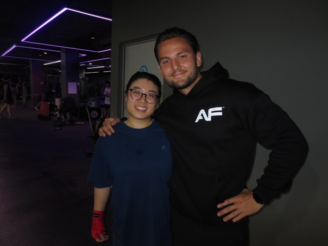 Baki smiling with a boxing student after training