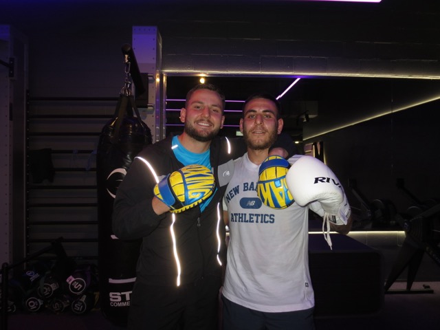 Baki smiling with a boxing student after a glove session