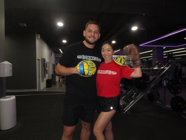 Baki smiling with a boxing student in the gym